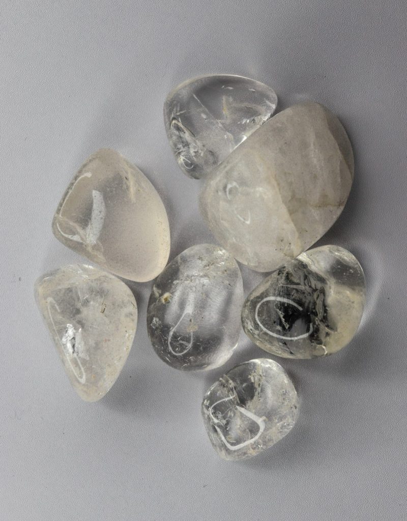 several-clear-tumbled-quartz-stones-on-a-light-background-vrkkfrral50